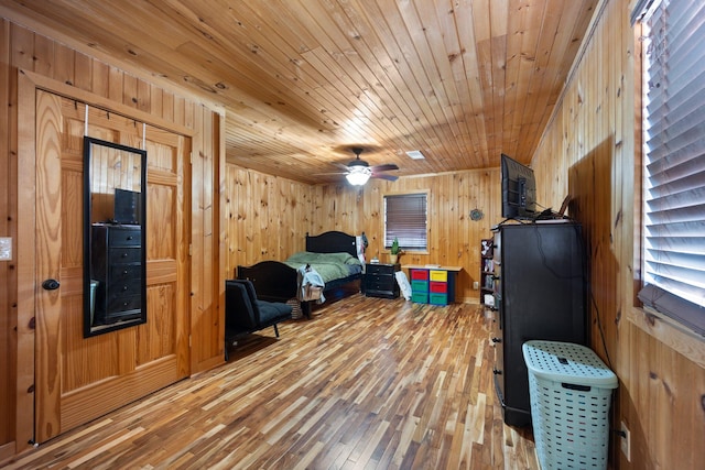 bedroom with hardwood / wood-style flooring, wooden walls, and wooden ceiling