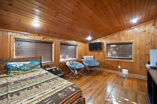 bedroom featuring lofted ceiling, wooden walls, hardwood / wood-style flooring, and wooden ceiling