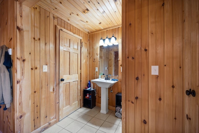 bathroom with tile patterned flooring, wood ceiling, and wooden walls