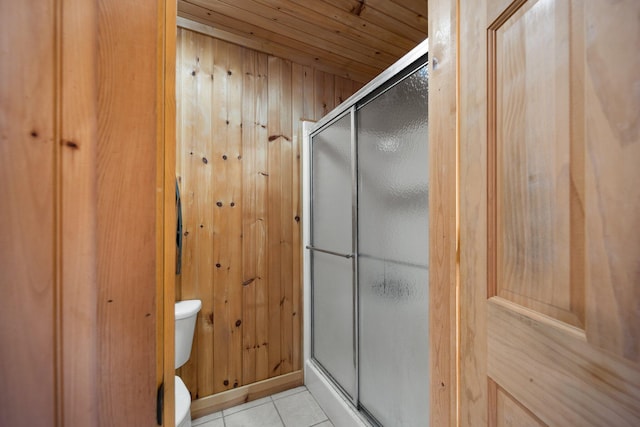 bathroom with toilet, wood walls, an enclosed shower, wooden ceiling, and tile patterned flooring