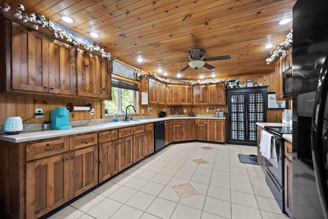 kitchen with wood ceiling, sink, wooden walls, black appliances, and light tile patterned floors