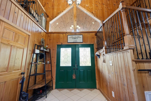 entrance foyer with wooden walls and a high ceiling