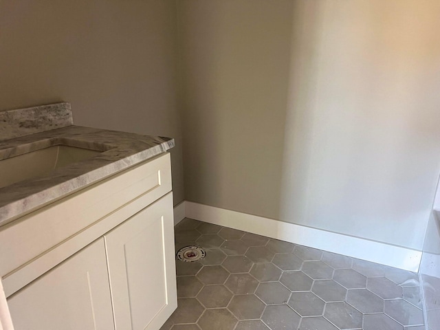 bathroom with tile patterned floors and vanity