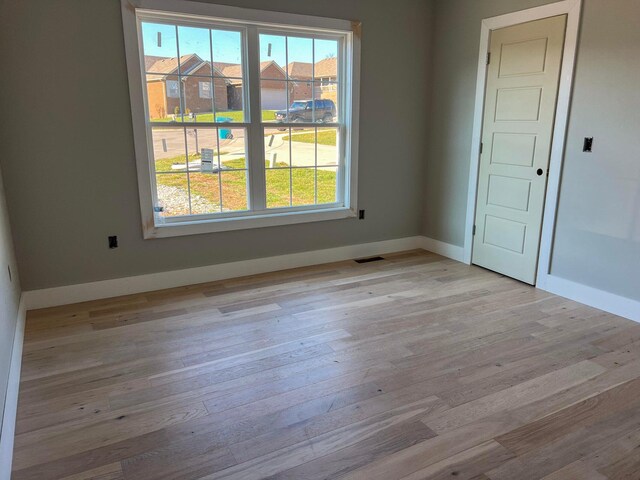 unfurnished room featuring plenty of natural light and light hardwood / wood-style flooring