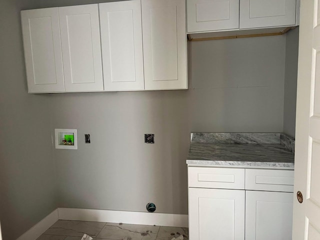 laundry room featuring hookup for a washing machine and cabinets