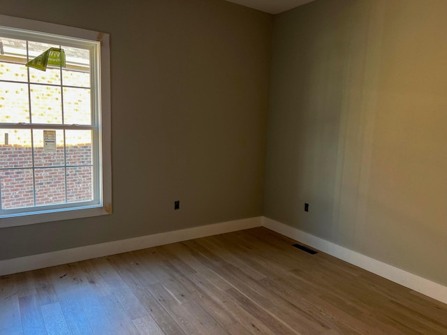 unfurnished room with light hardwood / wood-style flooring