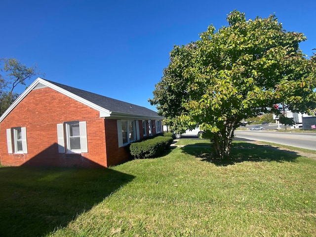 view of side of home featuring a lawn