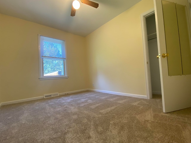 unfurnished bedroom with light colored carpet and ceiling fan