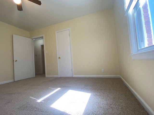 unfurnished bedroom featuring carpet and ceiling fan