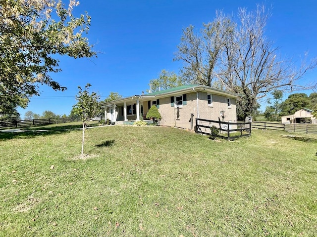 back of house with a yard