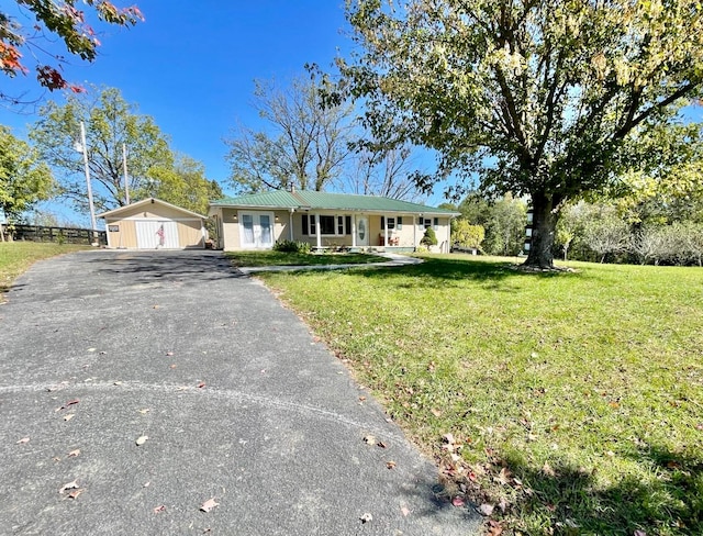 single story home with a storage unit and a front lawn