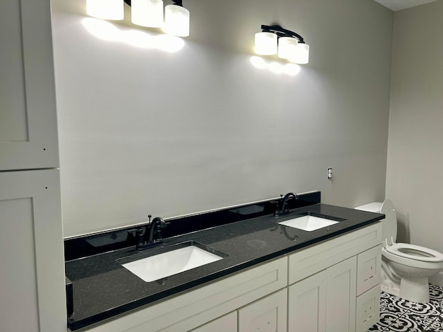 bathroom with vanity, toilet, and tile patterned floors