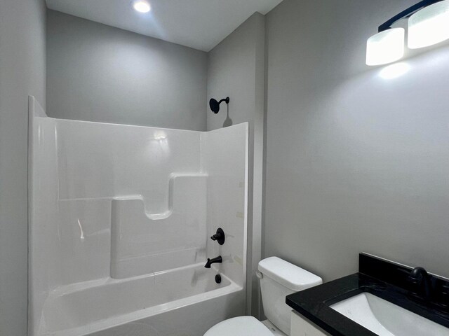 full bathroom featuring shower / bathing tub combination, vanity, and toilet