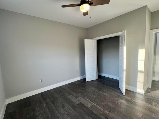 unfurnished bedroom featuring ceiling fan and dark wood-type flooring