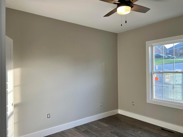 unfurnished room with ceiling fan and dark hardwood / wood-style flooring