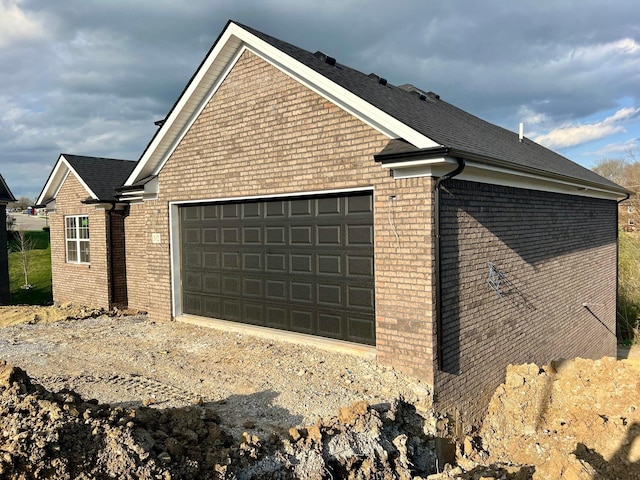 view of side of home with a garage