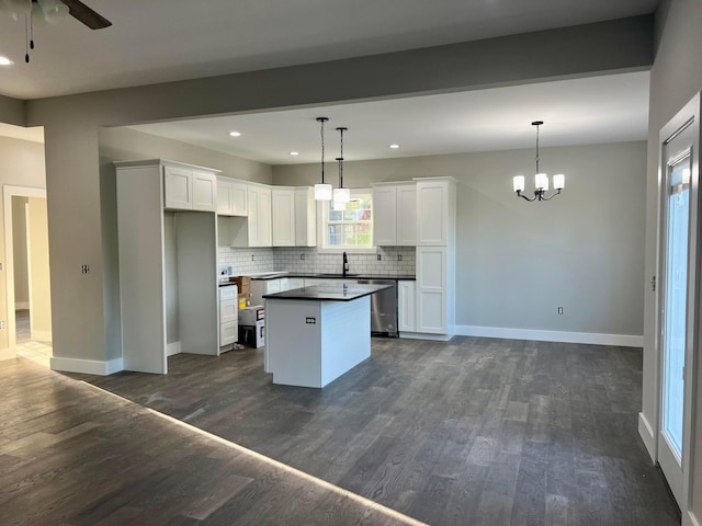 kitchen with decorative light fixtures, dark hardwood / wood-style flooring, a center island, and white cabinetry