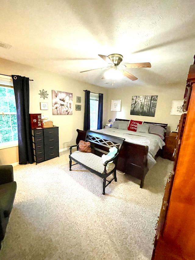 bedroom featuring ceiling fan and light carpet