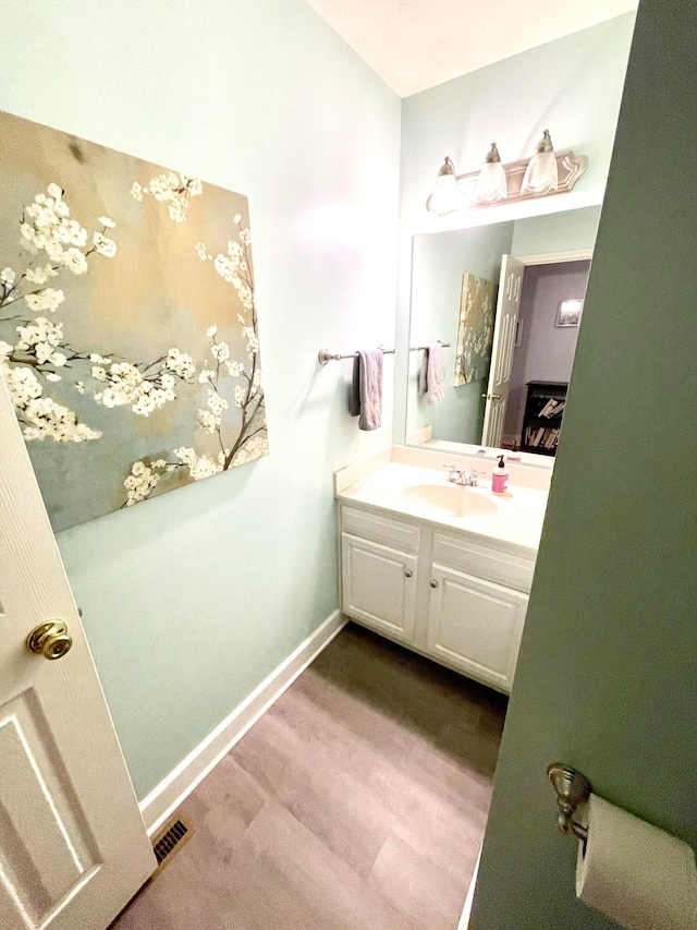 bathroom featuring hardwood / wood-style flooring and vanity