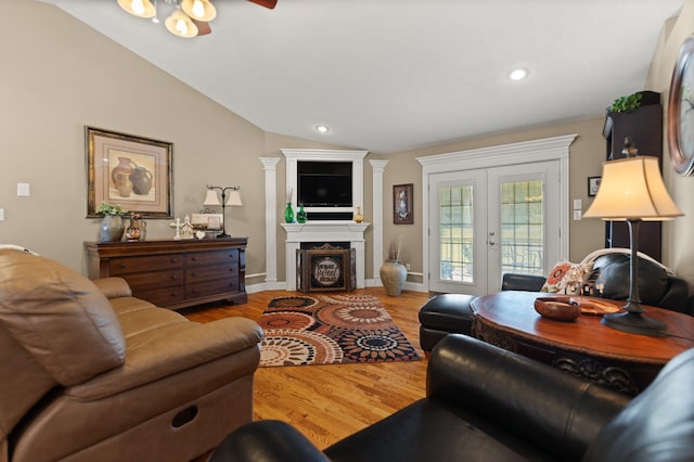 living room with french doors, lofted ceiling, light wood-type flooring, and ceiling fan