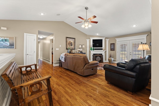 living room with ceiling fan, hardwood / wood-style flooring, lofted ceiling, and french doors