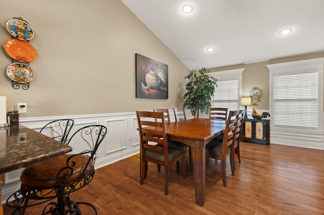 dining space featuring lofted ceiling and dark wood-type flooring