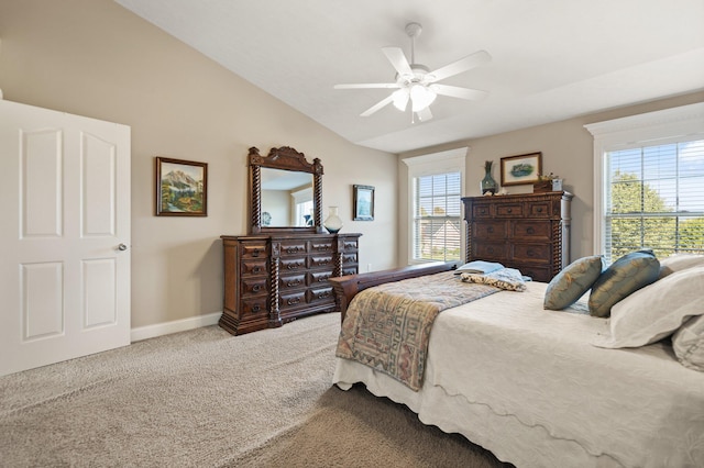 carpeted bedroom with ceiling fan and vaulted ceiling