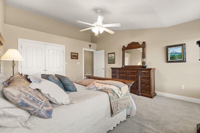 carpeted bedroom featuring ceiling fan, a closet, and vaulted ceiling