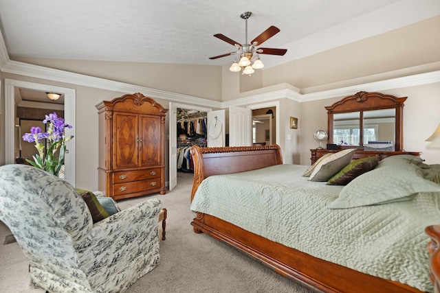 bedroom with a spacious closet, ceiling fan, a closet, and light colored carpet