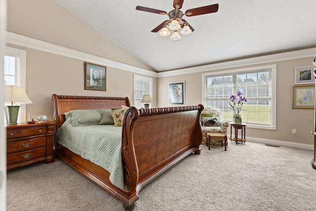 bedroom with ornamental molding, ceiling fan, vaulted ceiling, and carpet flooring