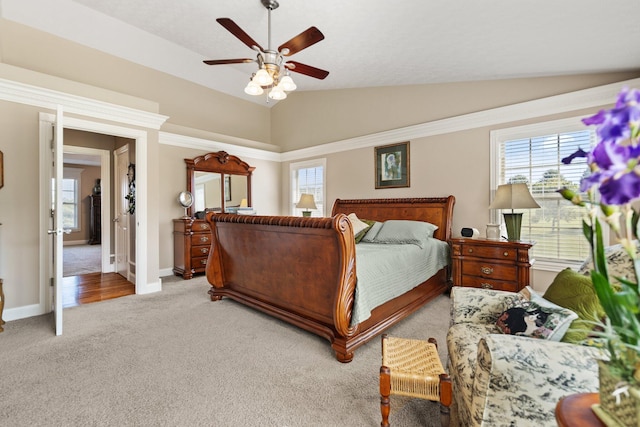 carpeted bedroom featuring ceiling fan and vaulted ceiling