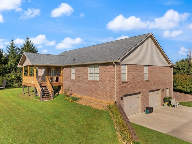 back of property with a garage and a lawn