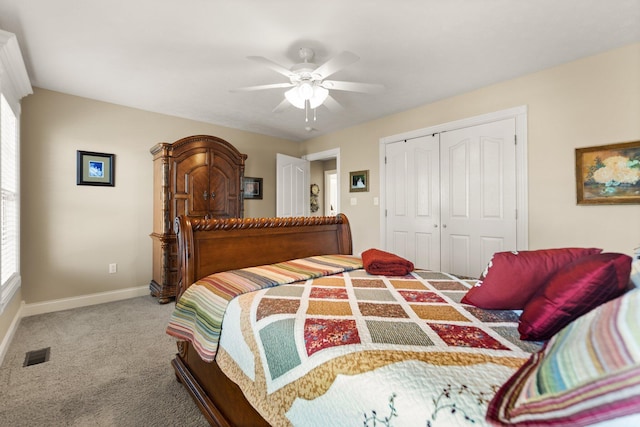 carpeted bedroom featuring a closet and ceiling fan