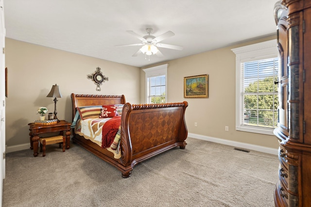 bedroom with ceiling fan and light carpet