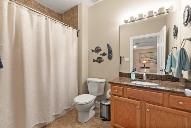 bathroom featuring walk in shower, vanity, toilet, and tile patterned floors