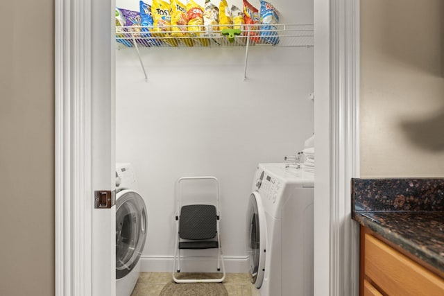 washroom with light tile patterned flooring and washer and dryer