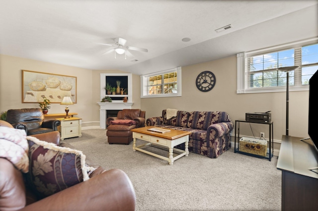 living room featuring ceiling fan, a wealth of natural light, and carpet