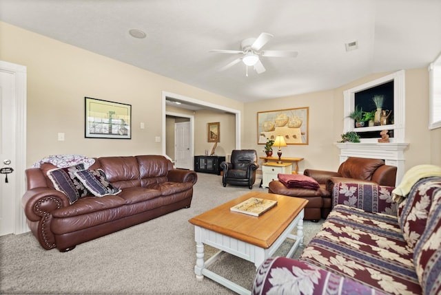 carpeted living room with ceiling fan