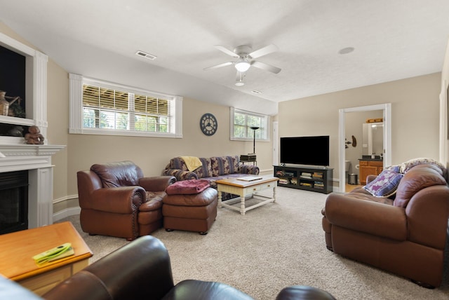 carpeted living room with ceiling fan