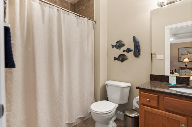 bathroom featuring tile patterned flooring, walk in shower, ceiling fan, toilet, and vanity