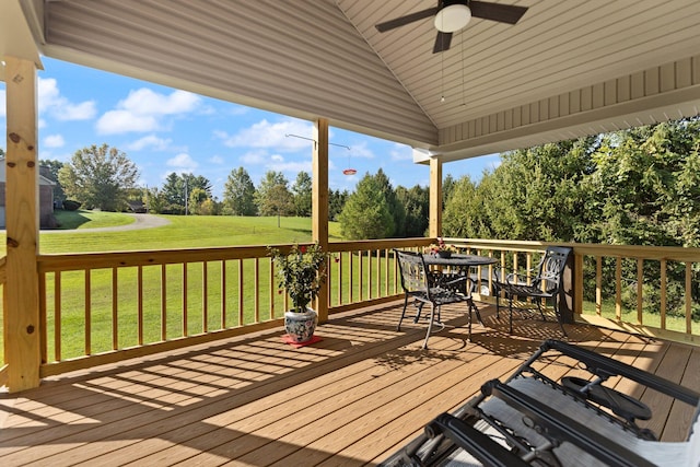 wooden deck with a yard and ceiling fan