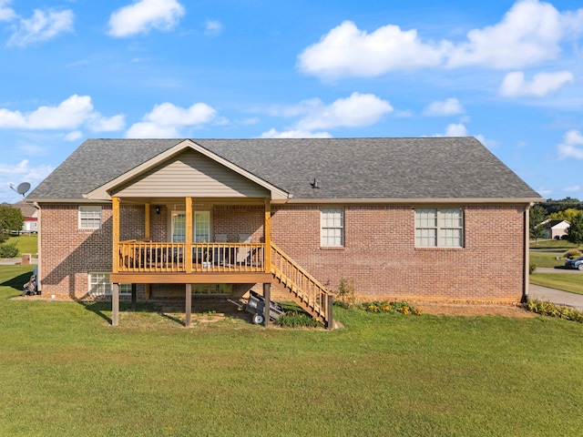 rear view of property featuring a lawn