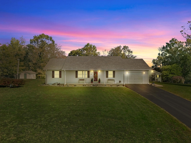 ranch-style home with a front yard, a garage, and driveway