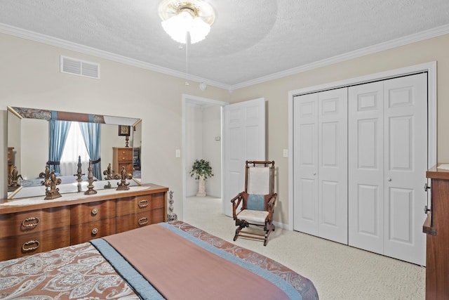 bedroom featuring visible vents, a textured ceiling, crown molding, and carpet floors