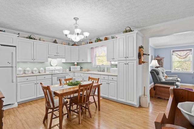 kitchen featuring white appliances, light hardwood / wood-style flooring, decorative light fixtures, ornamental molding, and white cabinetry