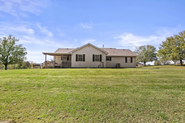 rear view of property with a yard and a shingled roof