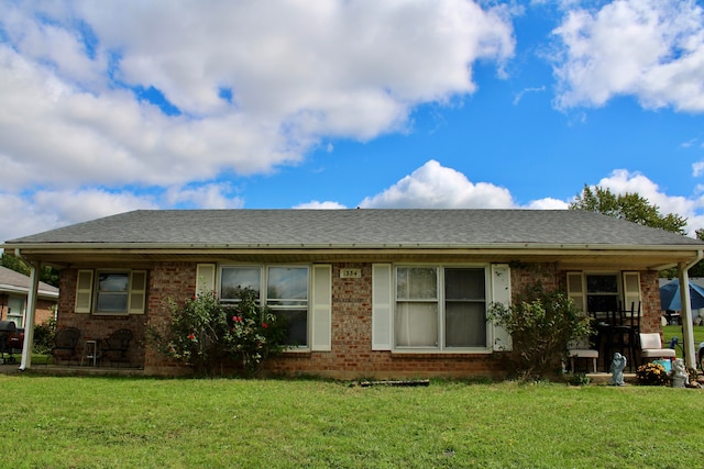 rear view of property featuring a lawn