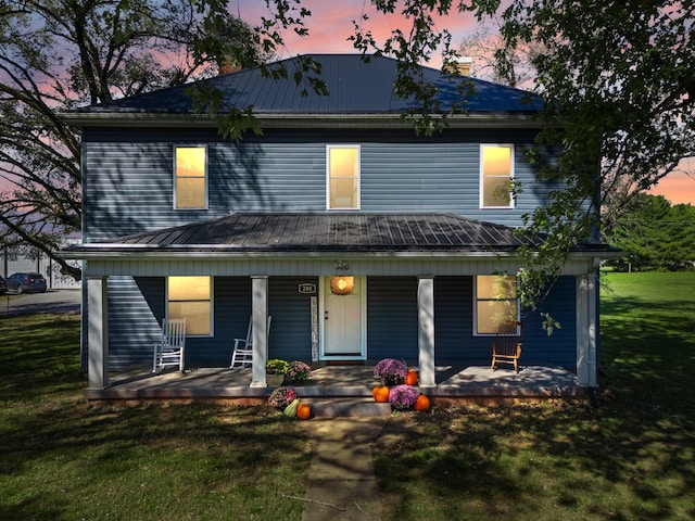 view of front of house featuring a yard and a porch