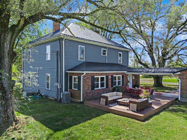 back of house featuring cooling unit, a yard, and a patio