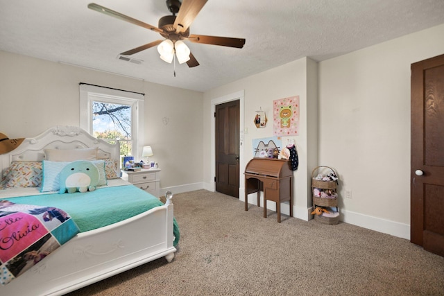 carpeted bedroom featuring ceiling fan and a textured ceiling